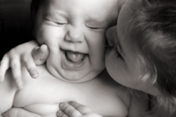 bambina da un grosso bacio a neonato felice